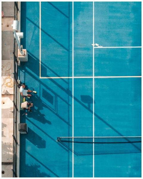 Top-down view of a blue tennis court in Miami, sho