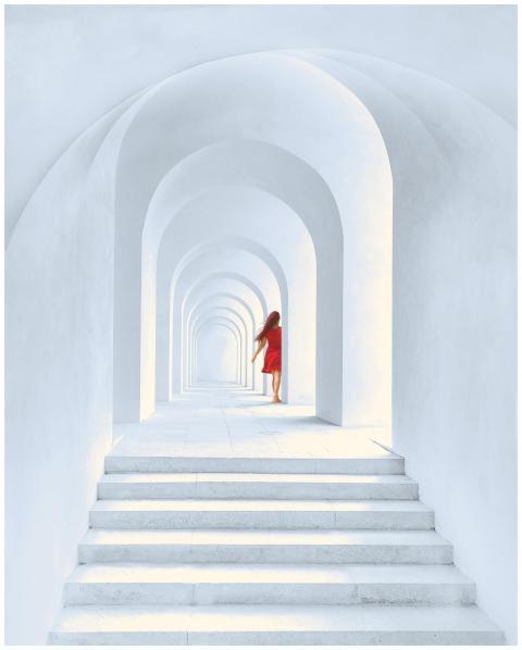 A woman in a red dress walks through a series of w