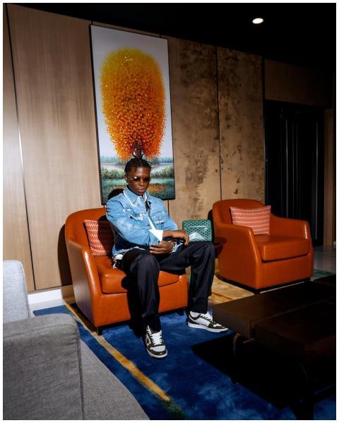 Fashionable man reading in a contemporary hotel lo