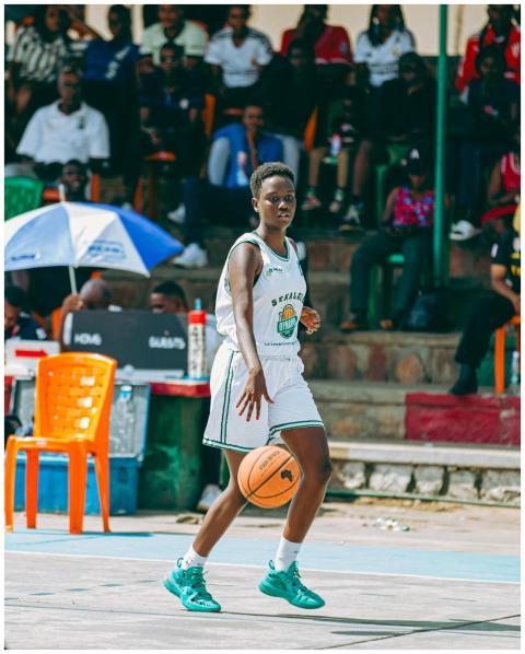 An athlete dribbling a basketball during an outdoo