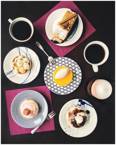 An artistic flat lay of assorted pastries and coff