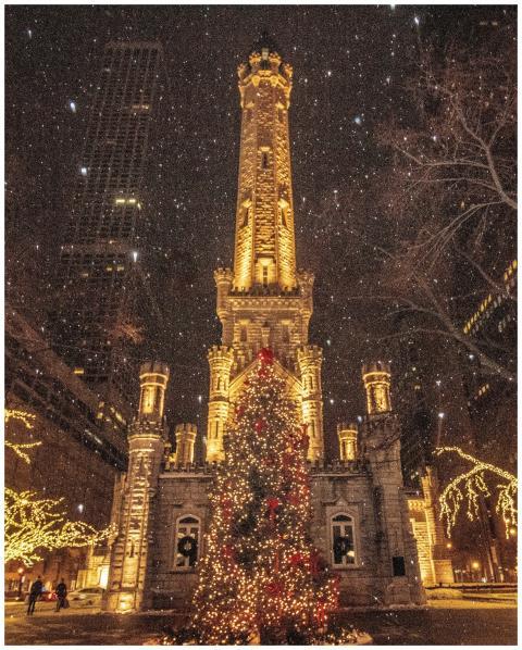 Night view of a historic water tower adorned with