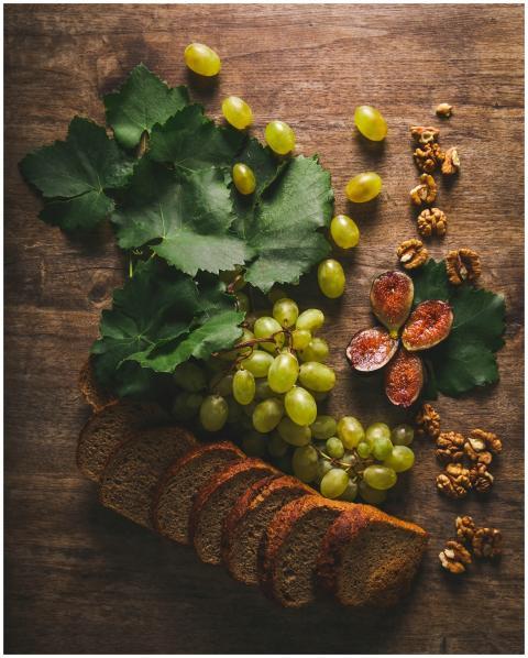 Rustic still life of grapes, sliced bread, figs, a