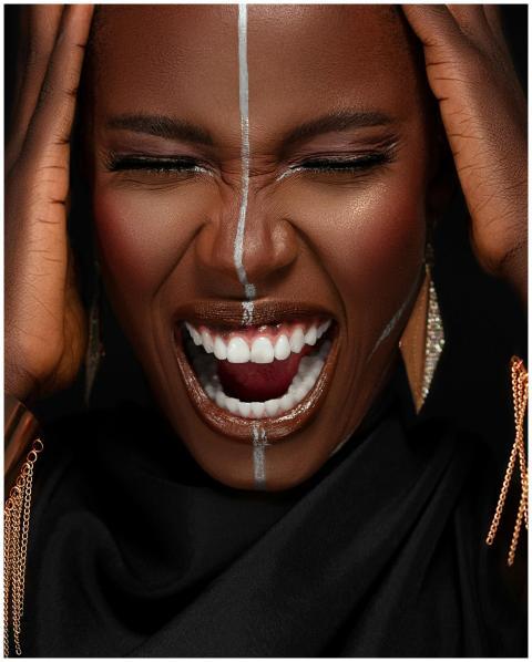 A close-up portrait of a woman with tribal makeup,