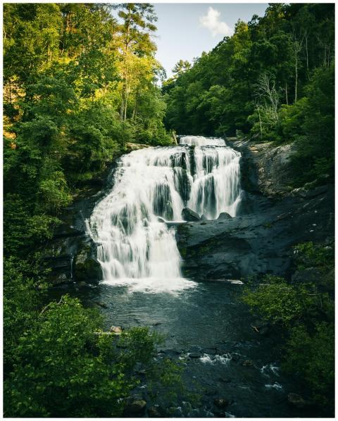 Beautiful waterfall cascading over rocks surrounde