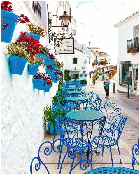 Picturesque outdoor café with vibrant blue chairs