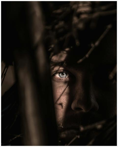 Close-up portrait capturing an intense gaze throug