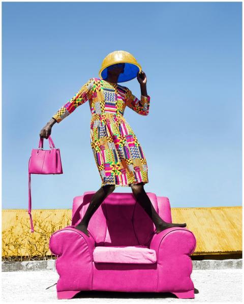 Colorful portrait of a stylish woman posing on a p