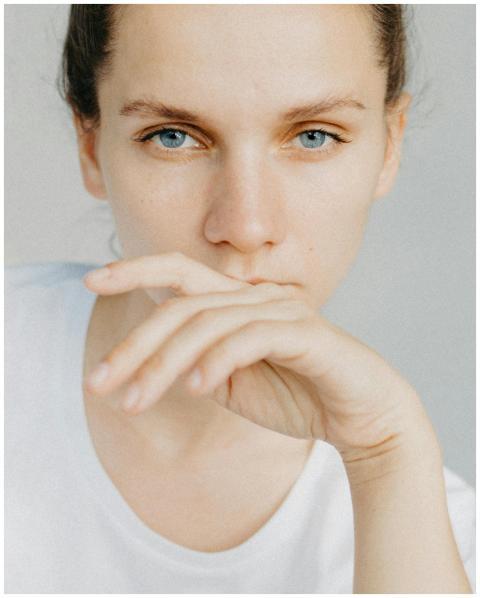 Close-up portrait of a woman with blue eyes, looki