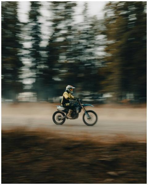 Blurred shot of a dirt bike rider speeding through