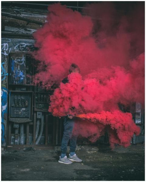 A man creating a dramatic scene with vibrant red s