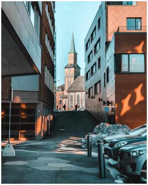 A city street scene featuring modern architecture,