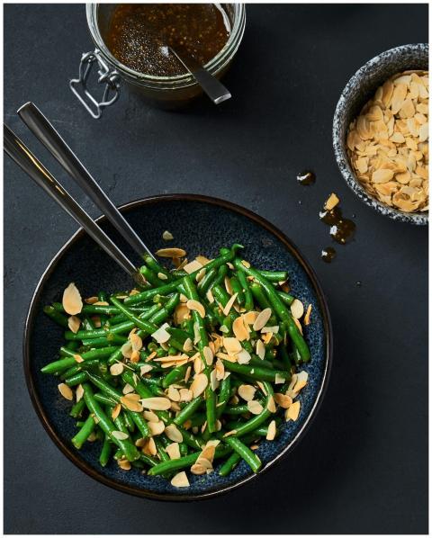 Green beans tossed with sliced almonds and dressin