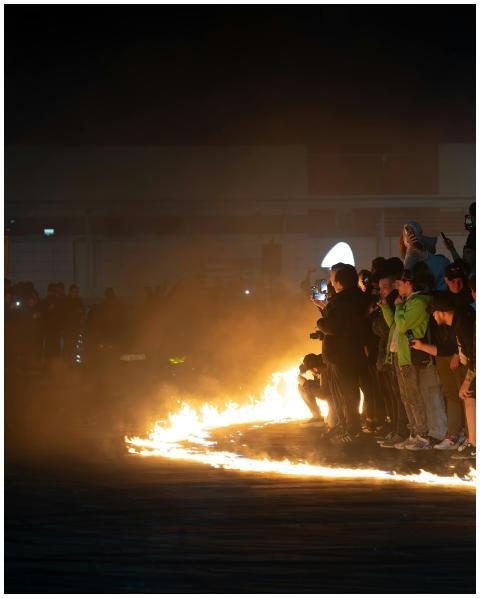 People gathered at a fiery spectacle at dusk in Wr