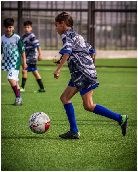 Young players engaged in a dynamic soccer match on