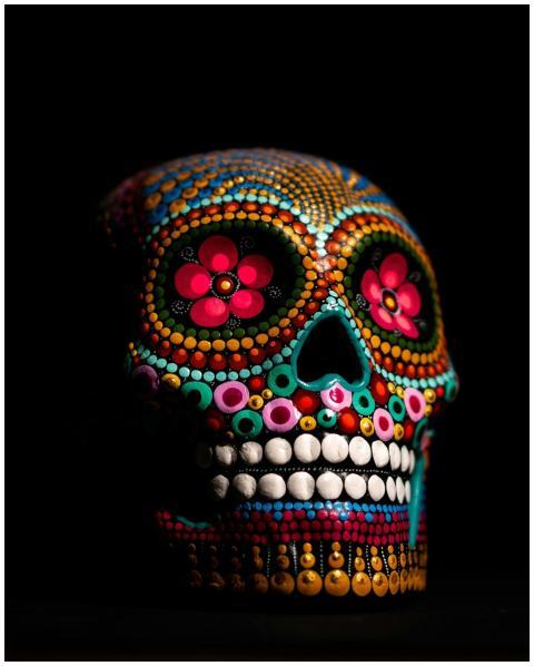 A vibrant and colorful sugar skull depicting Day o