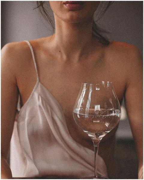 An elegant portrait of a woman in a satin top with