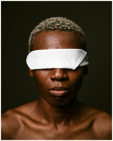Dramatic close-up portrait of a blindfolded person