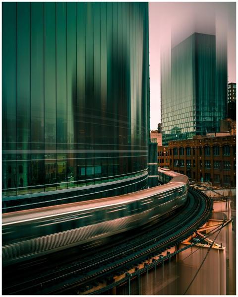 Long exposure of a train passing by modern skyscra