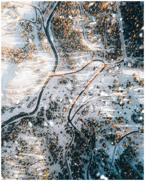 A stunning aerial view of a snow-covered forest in