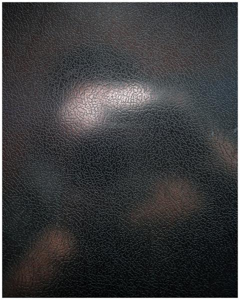 Close-up of a textured black leather surface with