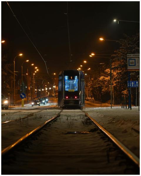 A tram moves through snowy streets of Wrocław at n