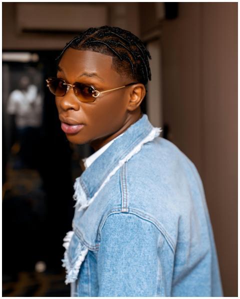 A fashionable young man wearing denim and sunglass