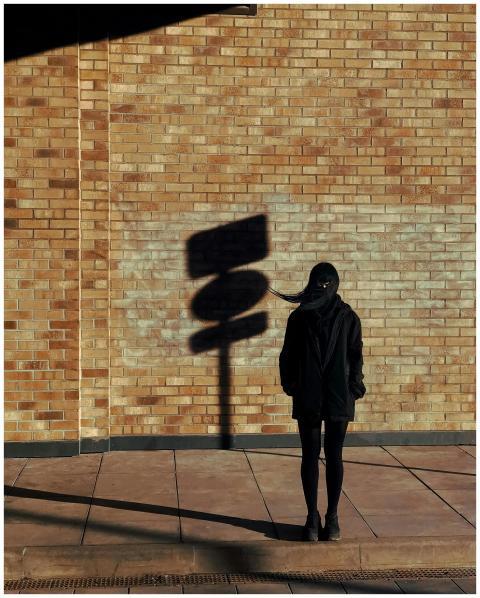 Silhouette Woman Against Brick