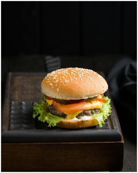 Close-up of a delicious cheeseburger with lettuce,