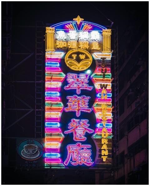 Bright neon sign of Tsui Wah Restaurant glowing in