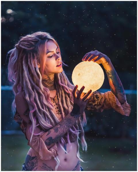 A whimsical outdoor portrait of a tattooed woman h