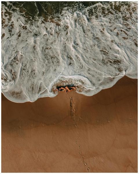 Aerial shot of a woman lying on Rio de Janeiro bea