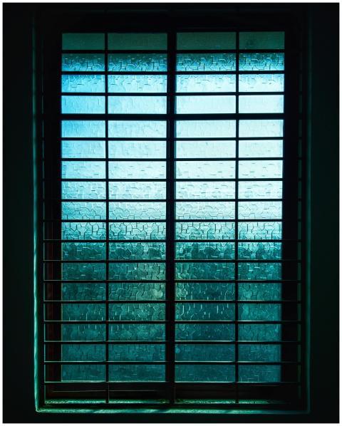 A modern window with geometric grill and textured