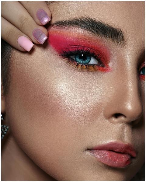 Close-up of a woman with bold makeup; featuring pi