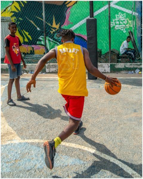 Energetic street basketball game played by teenage