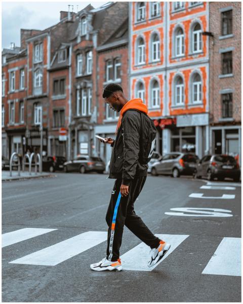 Person walking on a zebra crossing in Namur, captu