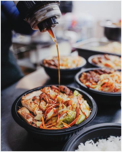 Flavorful Korean chicken rice bowl drizzled with r