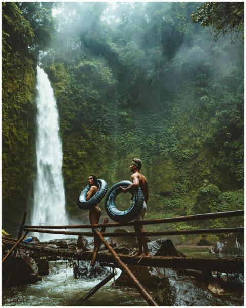 A couple in swimwear with float tubes exploring a