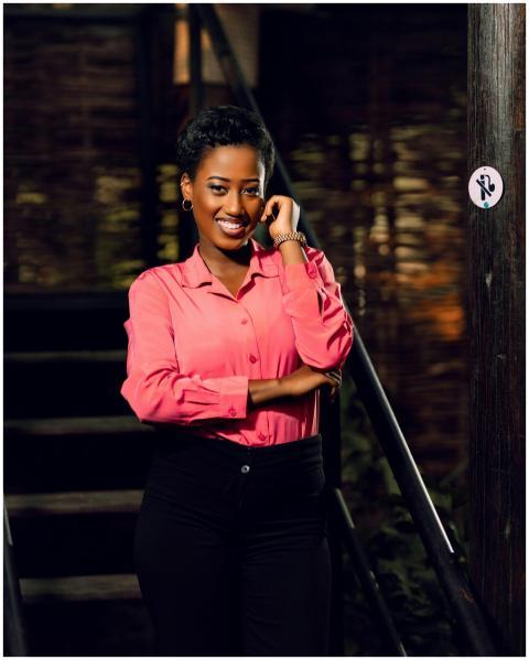 Smiling woman in a pink shirt confidently posing i