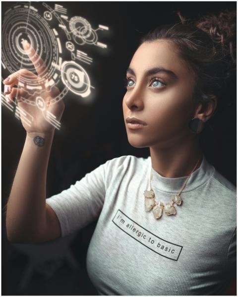 Woman in a modern setting interacting with a holog