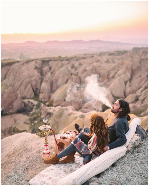 Couple enjoying a sunset picnic with a hookah on a