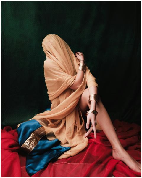 An artistic portrait of a model draped in vibrant