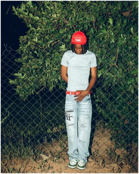 Fashionable young man wearing red cap and jeans st