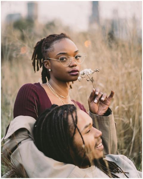 A couple enjoying a serene moment in a grassy fiel