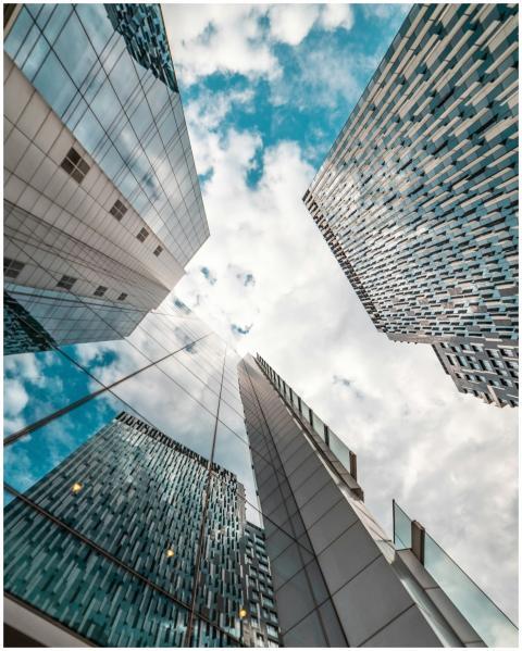 Low angle view of modern skyscrapers reflecting th