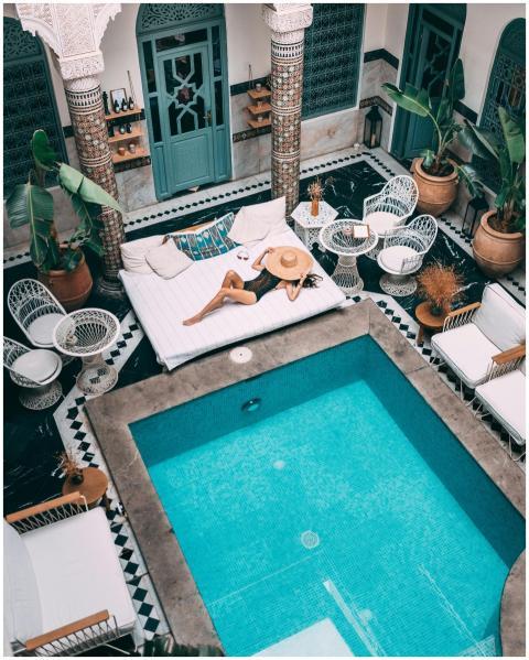 Elegant indoor pool with a woman lounging, set wit