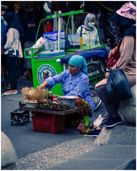 A woman street vendor selling traditional snacks o