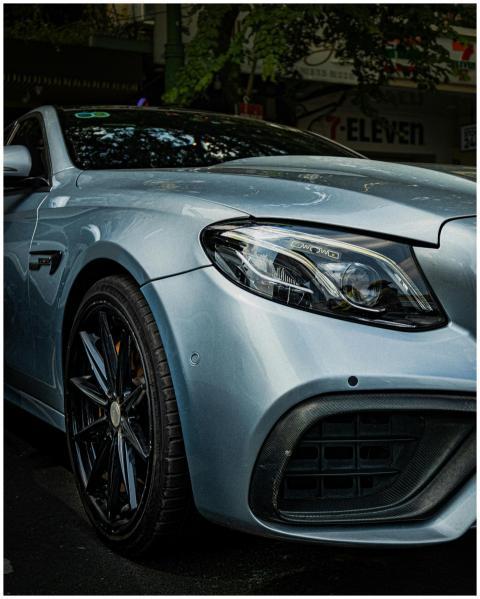 A sleek, silver luxury sedan parked in a city stre