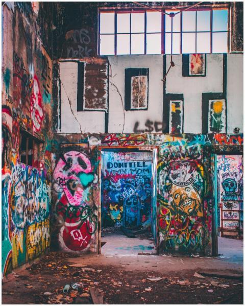 Colorful street art covers the walls of an abandon