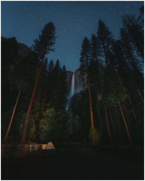 A stunning view of Yosemite Falls under a starry n